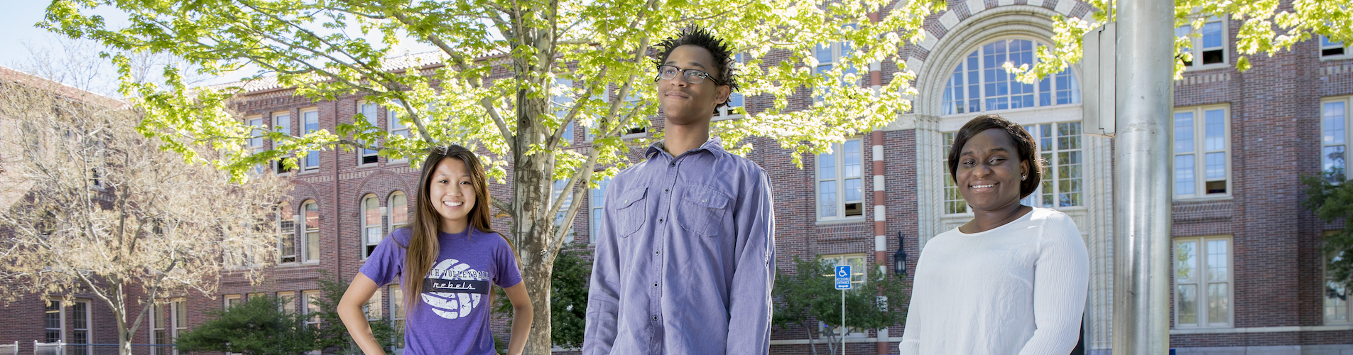 3 students in front of school